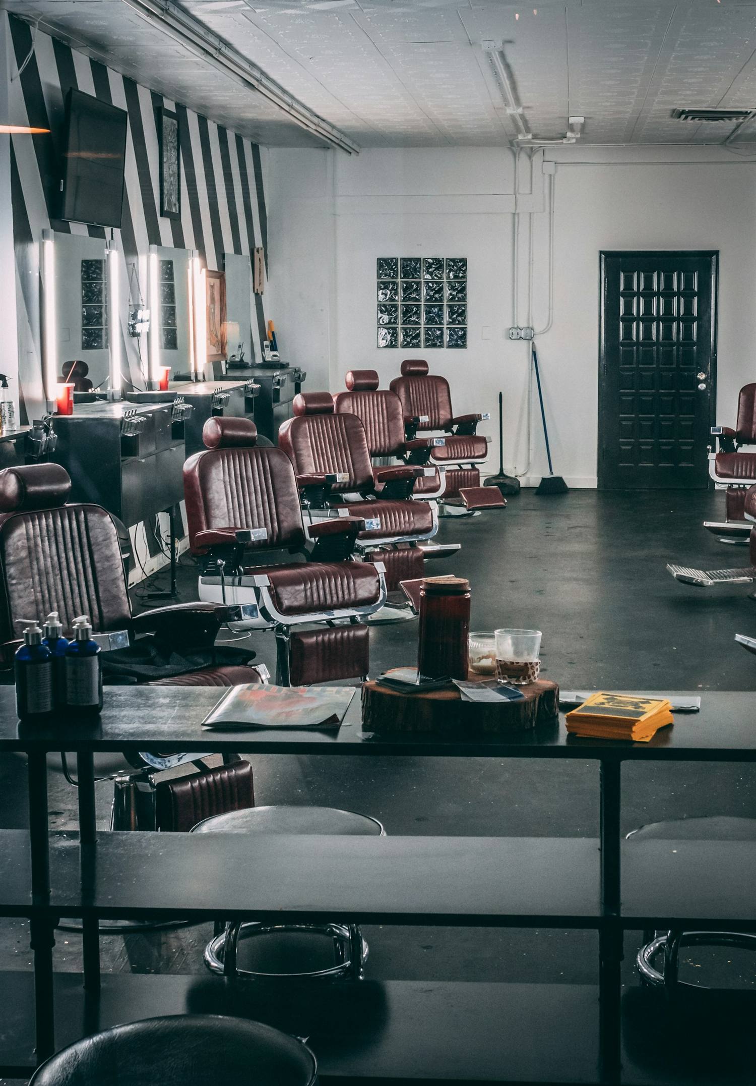 Barbershop interior with a row of empty leather chairs